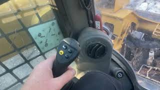 Operator controls on a Caterpillar 299D3 track loader.